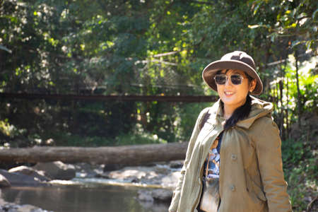 Travelers thai women people travel visit Mae sa waterfalls and rest relax outdoor in jungle wild...