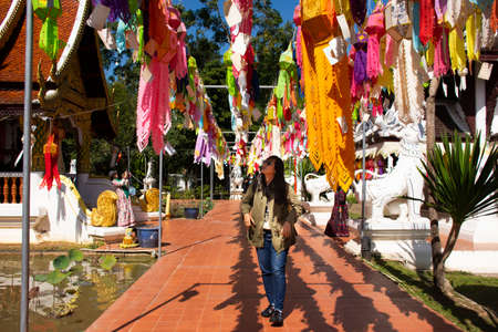 Traveler thai women people travel visit multicolor colorful paper lamp traditional lanna style Yee peng or lighting lantern tung at Wat Pa Daraphirom Temple on December 2, 2020 in Chiang Mai, Thailandのeditorial素材