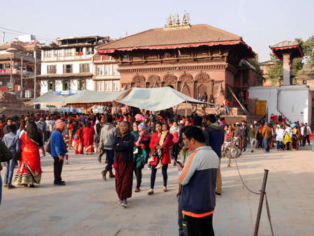 Nepali people and foreign travelers walking travel visit ancient ruins antique building and respect praying deity angel god at Basantapur Katmandu durbar square on December 2, 2017 in Kathmandu, Nepalのeditorial素材