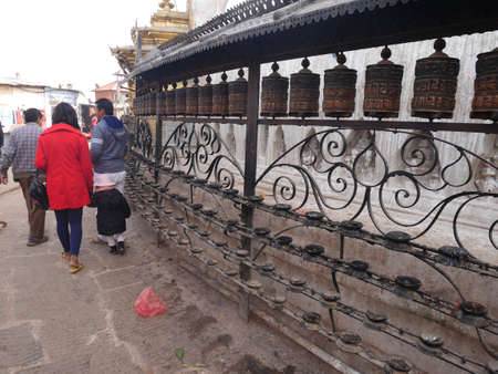 Prayer wheels on wall of Hariti shrine or Ajima Hindu Temple at Swayambhunath pagoda or Monkey Temple for napali people foreign traveler rotate respect praying on December 2, 2017 in Kathmandu, Nepalのeditorial素材