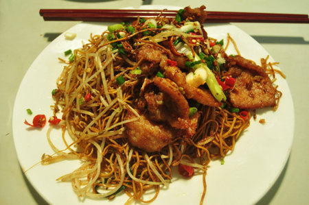 Macanese local food noodles fried with vegetable and meat pork lunch meal to Macau people and foreign traveler eat drink in restaurant at Senado Senate Square or Largo do Senado in Macau Region, Chinaのeditorial素材