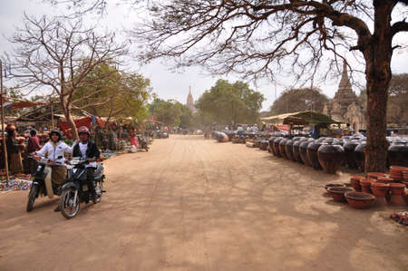 Burmese people and foreign travelers walking travel visit and buy shopping food souvenir gift product in street bazaar market fair in Bagan or Pagan on February 3, 2013 in Mandalay, Myanmar or Burmaのeditorial素材