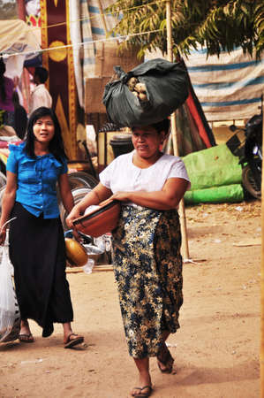 Burmese people and foreign travelers walking travel visit and buy shopping food souvenir gift product in street bazaar market fair in Bagan or Pagan on February 3, 2013 in Mandalay, Myanmar or Burmaのeditorial素材