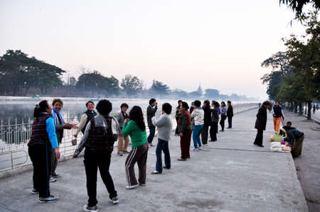Local life lifestyle of burmese old women people group friends dancing exercise aerobic beside road at water moat canal of Mandalay Palace on morning on February 3, 2013 in Mandalay, Myanmar or Burmaのeditorial素材