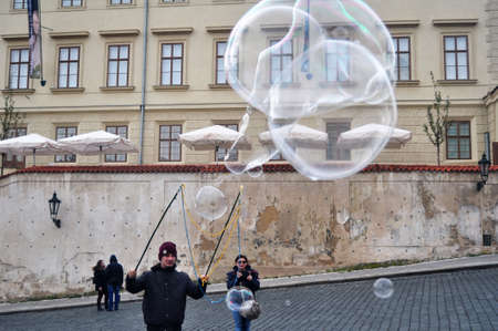 Czechia people playing unbreakable giant bubbles for show Czech people and foreigner travelers travel visit on patio castle Old Town Square of Praha city on December 11, 2016 in Prague, Czech Republicのeditorial素材