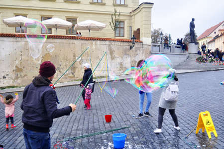 Czechia people playing unbreakable giant bubbles for show Czech people and foreigner travelers travel visit on patio castle Old Town Square of Praha city on December 11, 2016 in Prague, Czech Republicのeditorial素材