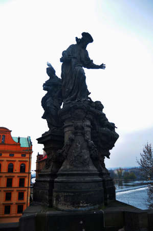 Cultural monument and ancient ruin antique stone statue on Charles Bridge crossing Vltava Moldau river for Czechia people and foreign travelers travel visit at Praha city in Prague, Czech Republicのeditorial素材