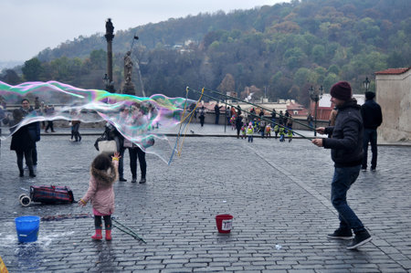 Czechia people playing unbreakable giant bubbles for show Czech people and foreigner travelers travel visit on patio castle Old Town Square of Praha city on December 11, 2016 in Prague, Czech Republicのeditorial素材