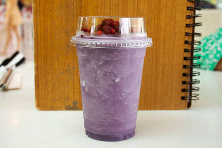 Blueberry fruits smoothie topping red berry served in plastic glass cup for travelers thai people rest relax eat and drink at restaurant cafe coffee shop in Bangkok, Thailandの写真素材