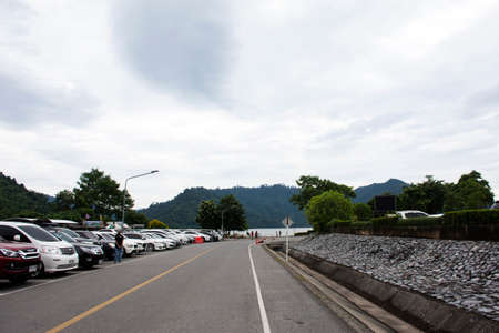 Thai people and foreign travelers stop car at parking for travel visit at Khun Dan Prakan Chon...