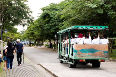 Thai people and foreign travelers travel visit walking and sit on tramcar tour trip on road street...