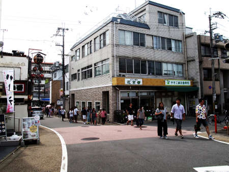 Japanese people and foreigner travelers travel journey and walking on street go to passengers train at Fushimi - Inari railway station at Kyoto old town city on July 11, 2015 in Kansai region, Japanのeditorial素材