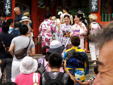 Travelers japanese women people wearing traditional clothes kimono yukata and travel visit respect praying and take photo at Yasaka Jinja Shinto Shrine at Kyoto city on July 11, 2015 in Kansai, Japanのeditorial素材
