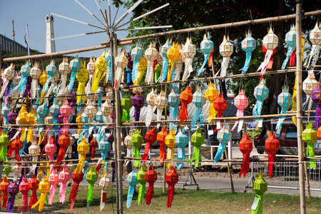 Multicolor colorful paper lamp traditional lanna style Yee peng or lighting lantern tung and flag hanging at outdoor for thai people travel respect praying in Wat Prasat temple of Nonthaburi, Thailandのeditorial素材