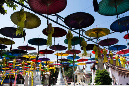 Colorful umbrellas hanging in event Loy Krathong festival of Wat Prasat temple of Nonthaburi for thai people and foreign traveler travel visit respect praying on November 28, 2021 in Bangkok, Thailandのeditorial素材