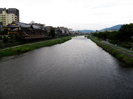 View landscape cityscape and life lifestyle japanese people rest relax with antique vintage retro buildings town at riverside Kamo river evening at Kyoto city on July 11, 2015 in Kansai region, Japanのeditorial素材
