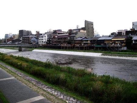 View landscape cityscape and life lifestyle japanese people rest relax with antique vintage retro buildings town at riverside Kamo river evening at Kyoto city on July 11, 2015 in Kansai region, Japanのeditorial素材