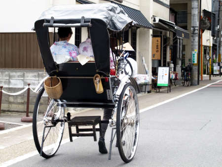 Classic antique vintage retro rickshaw trishaw or bicycle cart for japanese people and foreign travelers use service journey travel visit Arashiyama old town at Kyoto on July 11, 2015 in Kansai, Japanのeditorial素材