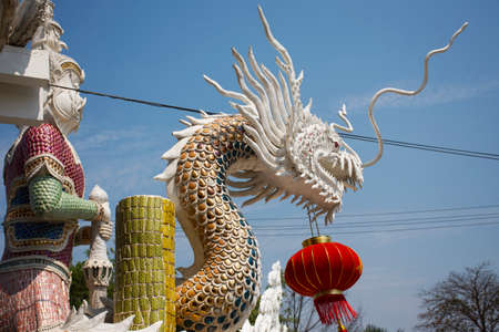 King Thao Wessuwan or Vasavana Kuvera giant statue and chinese dragon for thai people visit respect pray at Wat Pracha Rat Bamrung or Rang Man temple at Kamphaeng Saen city in Nakhon Pathom, Thailandのeditorial素材