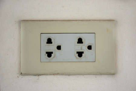 Classic power socket or old electrical outlet on white wall for thai people use energy electricity...