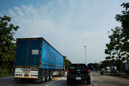 Traffic light intersection with thai people  travelers riding motorcycle and driving vehicle car and...
