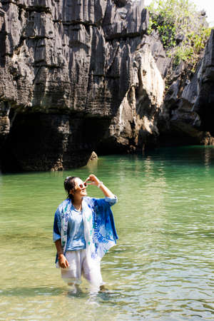 Traveler thai women travel visit and posing portrait for take photo in sea ocean at Ko Khao Yai...