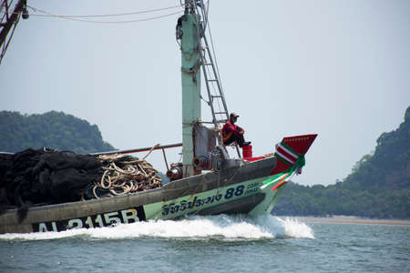 Thai fisher people sailing fishing boat ship in sea after catch fish and marine life in ocean of...