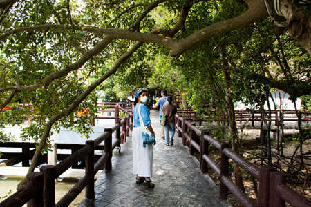 Travelers thai women travel visit and walk on stone bridge of time travel journey zone in sea ocean of Mu Ko Petra National Park in Pak Bara village at La ngu city on April 11, 2022 in Satun, Thailandのeditorial素材