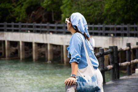 Travelers thai women travel visit and walk posing portrait on stone bridge of time travel journey zone in sea ocean of Mu Ko Petra National Park in Pak Bara village at La ngu city in Satun, Thailandの写真素材