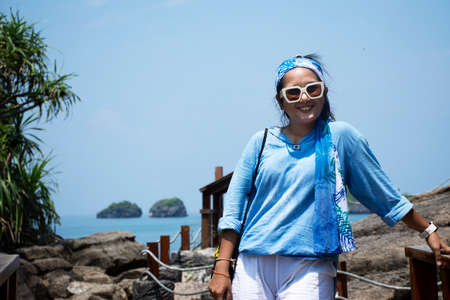 Travelers thai women travel walking relax and take photo on wooden bridge at Ao Toa Ba beach with unseen trip visit stone sea ââheart in ocean in Pak Bara waterfront at La ngu city of Satun, Thailandの写真素材