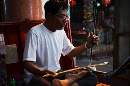 Thai people of chinese descent playing musical instruments sing song for acting traditional chinese contemporary classical opera for show local people at festival on March 13, 2011 in Bangkok Thailandのeditorial素材