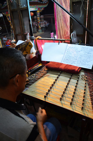 Thai people of chinese descent playing musical instruments sing song for acting traditional chinese contemporary classical opera for show local people at festival on March 13, 2011 in Bangkok Thailandのeditorial素材