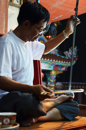 Thai people of chinese descent playing musical instruments sing song for acting traditional chinese contemporary classical opera for show local people at festival on March 13, 2011 in Bangkok Thailandのeditorial素材