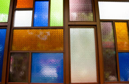Interior design decorate wooden window and wood door with colorful stained glass background in architecture building at Wat Sangkhatan temple in Bang Phai of Nonthaburi, Thailandの写真素材