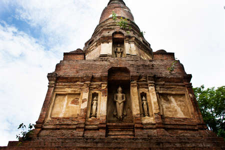 Ancient stupa or antique chedi and ruins buddha and ubosot for thai people traveler travel visit and respect praying blessing holy mystery of Wat Phra Kaew temple at Chainat city in Chai Nat, Thailandの写真素材