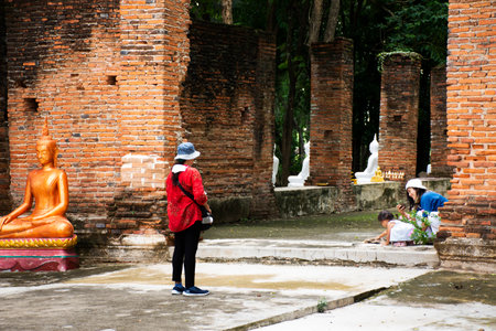 Ancient antique white buddha statue in antique ruin ubosot for thai people traveler travel visit and respect praying blessing holy mystery of Wat Phra Kaew temple at Chainat city in Chai Nat, Thailandのeditorial素材