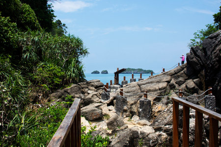 Walkway on cliff mountain for thai people foreign travelers travel visit unseen trip stone sea ââheart in ocean on Ao Toa Ba beach of Mu Ko Petra National Park in Pak bara at La ngu in Satun, Thailandのeditorial素材