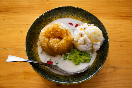 Local traditional thai dessert sweet meal and snack shaved ice with coconut ice cream on ceramic bowl serve for thai people customer eat drink on table at restaurant cafe shop in Chiang Rai, Thailandの写真素材