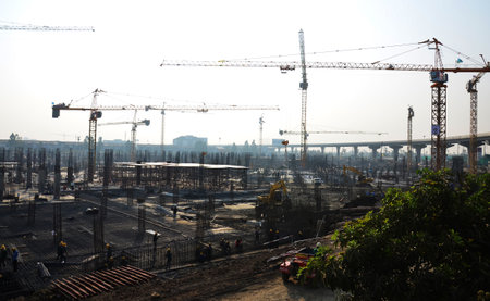 Asian labor people and thai labour workers use machine and heavy machinery working builder new structure tower high-rise building on scaffold at construction site at capital city in Bangkok, Thailandの写真素材