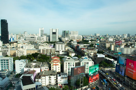 View landscape cityscape of bangkok city and high building tower condominium with thai people driving riding biking on street and traffic road busy jam on August Aerial 25, 2022 in Bangkok, Thailandのeditorial素材