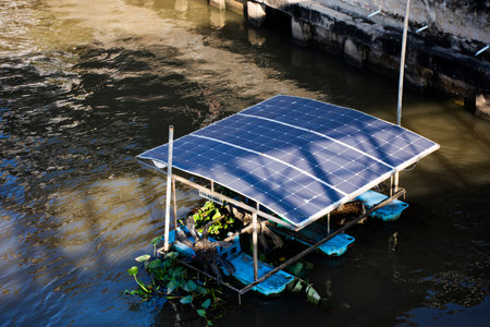 Oxygen generation surface aerator machinery in sludge wastewater working moving windmill system for treatment water use power from solar cell panel for made electricity in Pimonratch canal at Thailandの写真素材