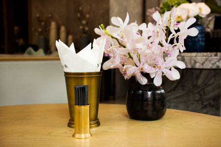 Tissue box and flower vase with tableware on table with furniture decorate interior design modern...