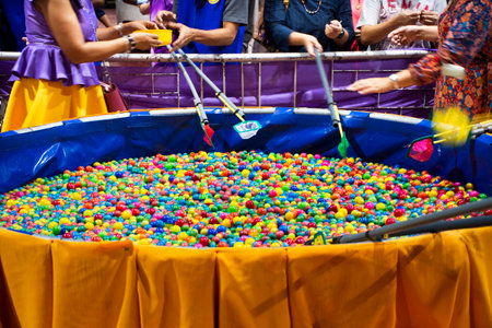 Lucky draw eggs scoop game for thai people travelers travel visit and buy tickets for playing gambler risk taking at shop in Loi Krathong event fatival fair at Wat Prasat temple in Nonthaburi Thailandの写真素材