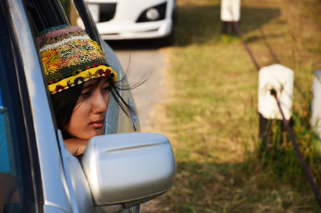 Travelers thai women people journey travel visit sitting in car and posing portrait for take photo at outdoor in Kaeng Krachan Dam reservoir at Kaengkrachan National Park in Phetchaburi, Thailandの写真素材