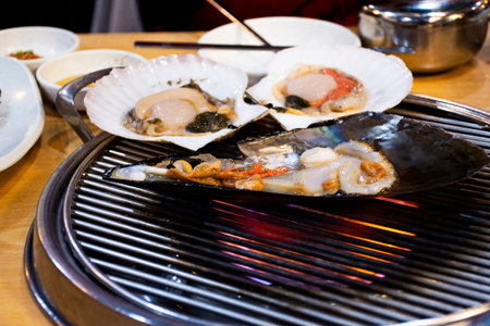 Gourmet food grilled roasted seafood and shell fried burn for korean people traveler travel visit and taste eat drinks cuisine in local restaurant at Hueundae Street Foodâ Market in Busan, South Koreaの写真素材