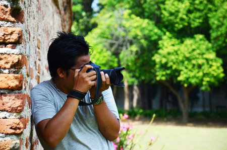 Thai men photographer travelers people travel visit and use digital camera shooting ancient ruins...