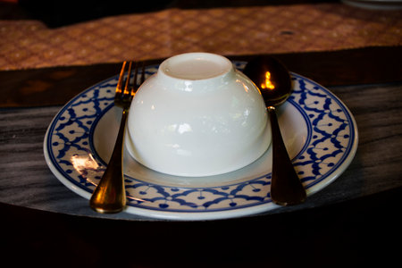 Cutlery bowl set or flatware and tableware on table with furniture decorate interior design modern dining room for guest customer use service eat drinks at luxury restaurant cafe in Bangkok, Thailandの写真素材
