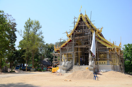 Thai workers people renovate repair and build scaffolding ancient ruin ubosot or antique ordination hall of Wat Phra That Doi Chom Thong temple at Chiangrai on February 22, 2015 in Chiang Rai Thailandのeditorial素材