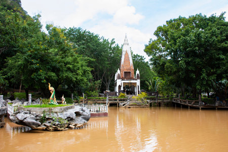 Ancient building and gardening park garden with mountain for thai travelers people travel visit respat praying in Wat Tham Khao Wong Temple at Ban Rai city on August 24, 2023 in Uthai Thani, Thailandのeditorial素材