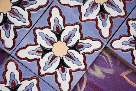 Handicraft retro tracery design ceramic and craft vintage marble tiles patterns on wall with graffiti street art in antique market 100 year arch bridge at Suratthani old town in Surat Thani, Thailandの写真素材